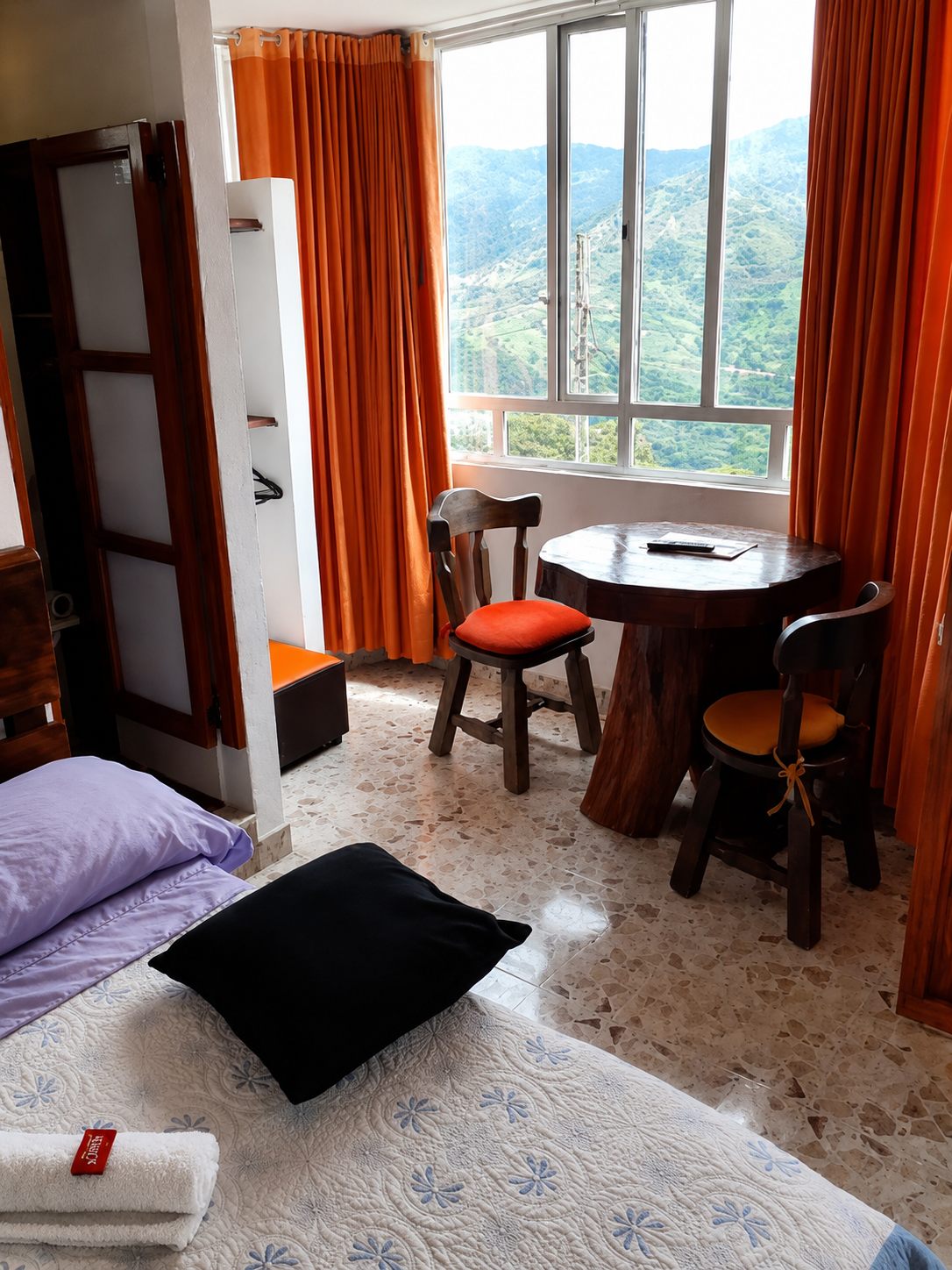 Habitación con mesa junto a la ventana y vista a la montaña